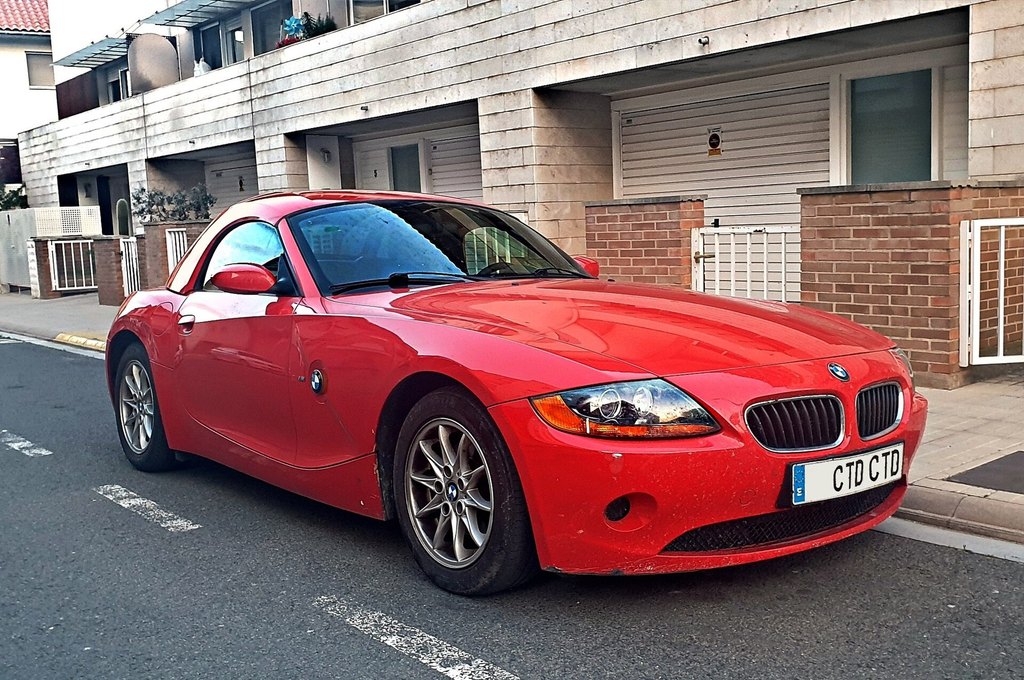 A red roadster parked on a street